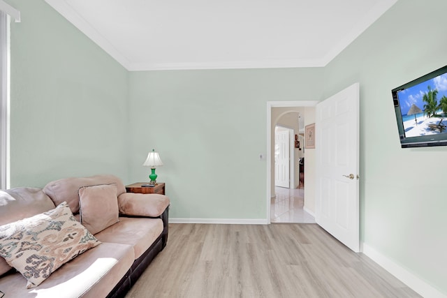 living room featuring light wood-type flooring and crown molding