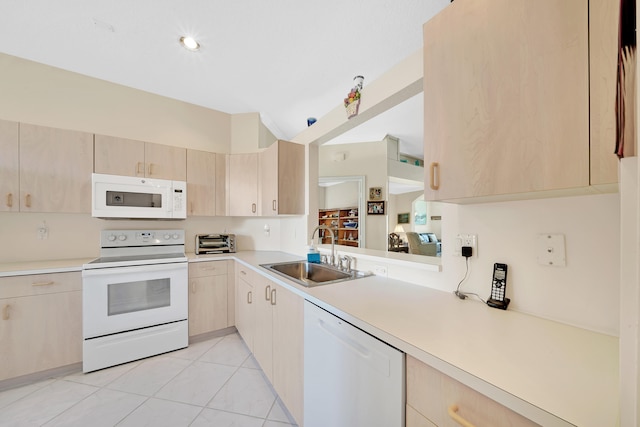 kitchen with sink, light brown cabinets, light tile patterned flooring, and white appliances