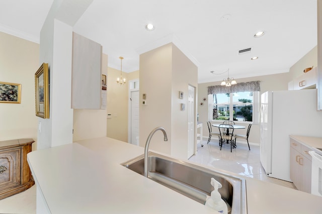 kitchen featuring sink, light tile patterned floors, a notable chandelier, hanging light fixtures, and white refrigerator