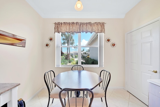 dining area with light tile patterned flooring and crown molding