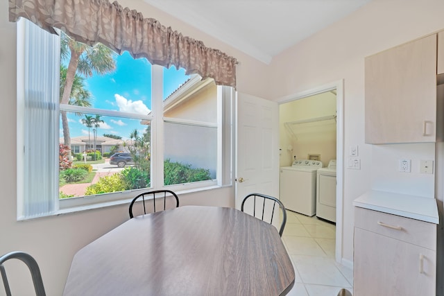 dining room with light tile patterned floors and washing machine and clothes dryer