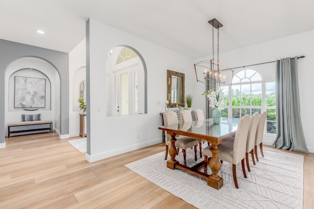 dining room featuring baseboards, light wood finished floors, recessed lighting, and an inviting chandelier