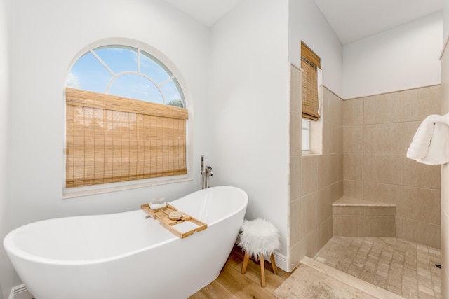 bathroom with wood-type flooring and a bathing tub