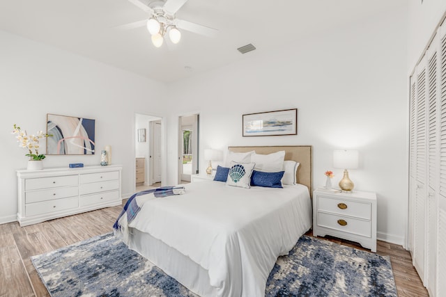 bedroom with a closet, light hardwood / wood-style flooring, and ceiling fan