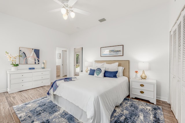 bedroom with light wood-style flooring, visible vents, and baseboards