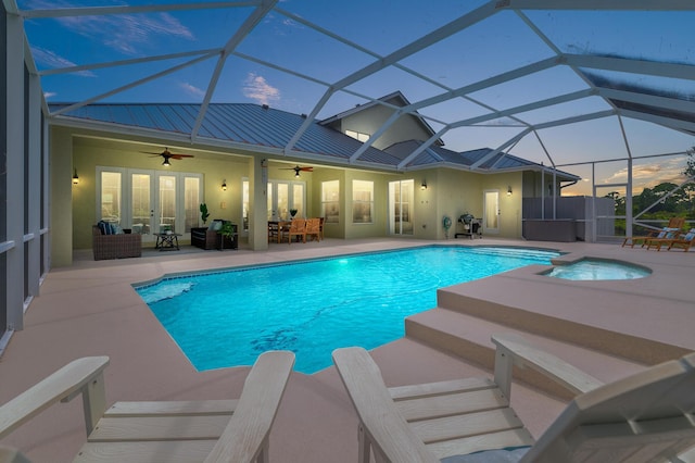 view of swimming pool featuring french doors, glass enclosure, outdoor lounge area, ceiling fan, and a patio area