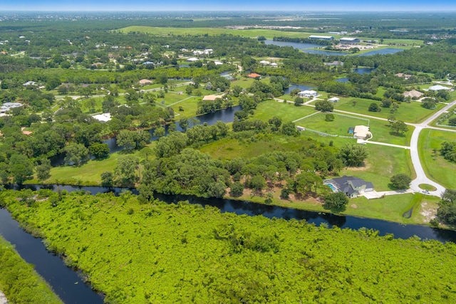 birds eye view of property featuring a water view and a forest view