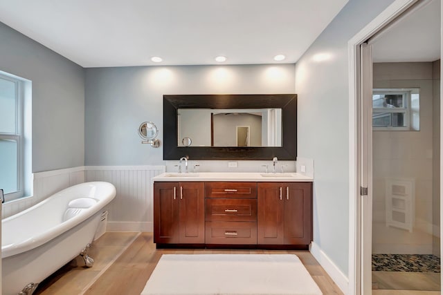 bathroom featuring vanity, shower with separate bathtub, and hardwood / wood-style floors