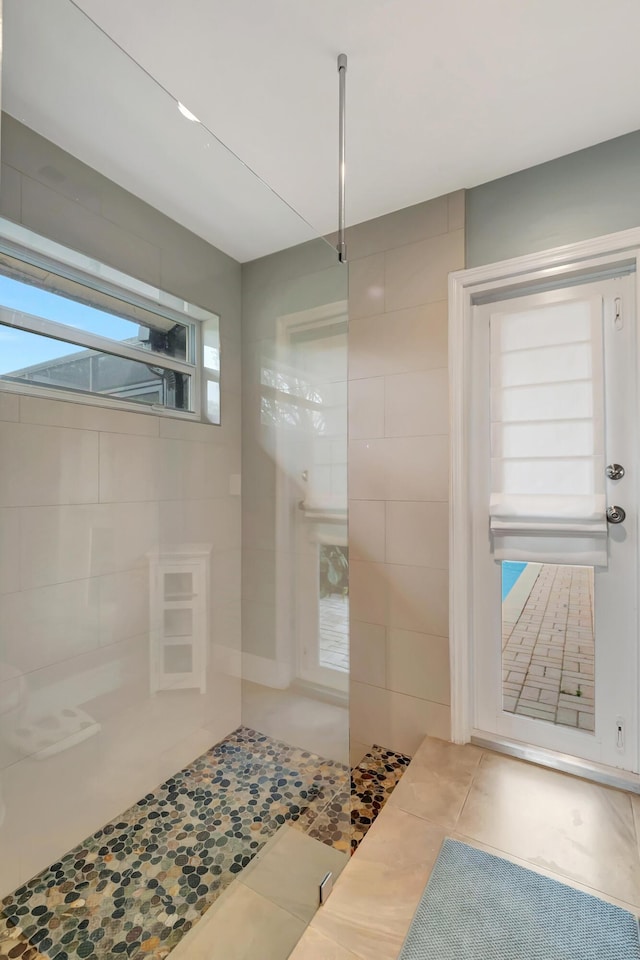 bathroom featuring tile patterned flooring and tile walls