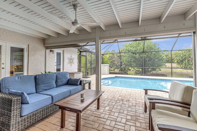 view of swimming pool with ceiling fan, an outdoor hangout area, a patio, and a lanai