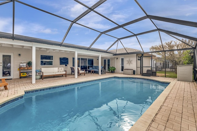 view of swimming pool featuring an outdoor living space, a patio, and glass enclosure