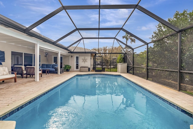 view of swimming pool featuring a patio, outdoor lounge area, and a lanai