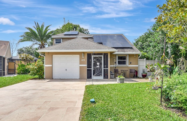 view of front facade featuring solar panels, concrete driveway, stucco siding, an attached garage, and a front yard