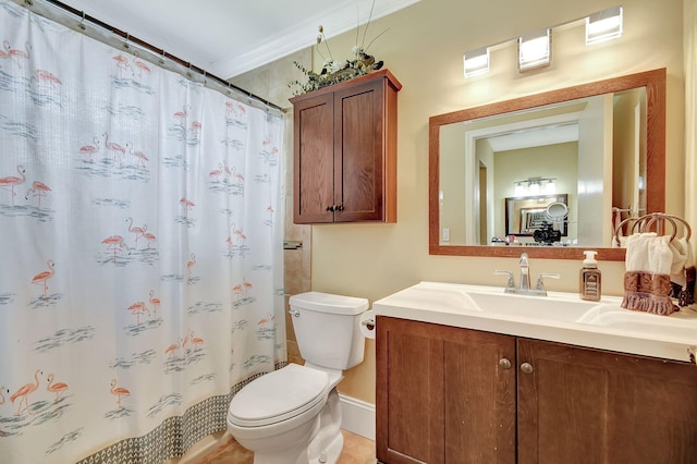 bathroom with vanity, crown molding, toilet, and curtained shower