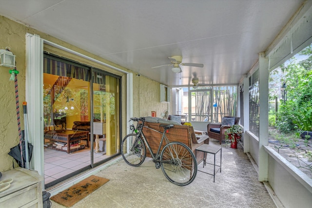 sunroom / solarium featuring ceiling fan