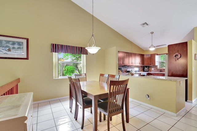 tiled dining room featuring high vaulted ceiling, a wealth of natural light, and ceiling fan