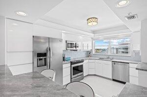 3212 S Ocean Blvd Unit 807-A, Highland Beach, FL 33487 - kitchen featuring a tray ceiling, stainless steel appliances, white cabinets, visible vents, and modern cabinets