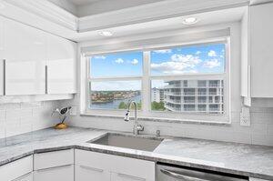 3212 S Ocean Blvd Unit 807-A, Highland Beach, FL 33487 - kitchen featuring a sink, stainless steel dishwasher, decorative backsplash, and white cabinets