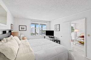 3212 S Ocean Blvd Unit 807-A, Highland Beach, FL 33487 - bedroom with a textured ceiling