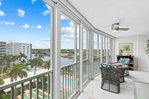 sunroom with a water view and ceiling fan