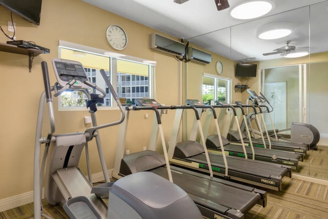 exercise room with a wall mounted AC and ceiling fan