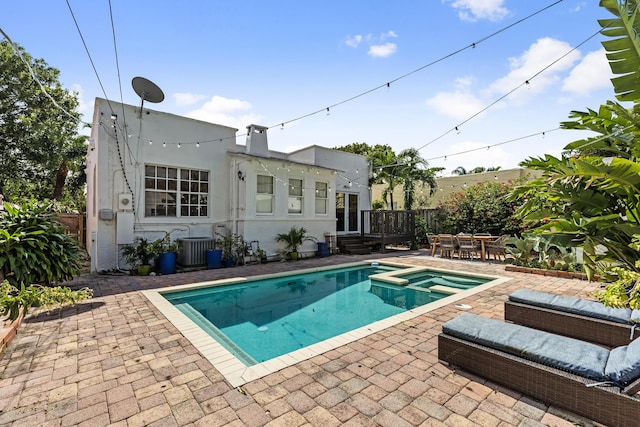 435 35th St, West Palm Beach, FL 33407 - view of pool featuring fence, central AC, a patio area, and a pool with connected hot tub