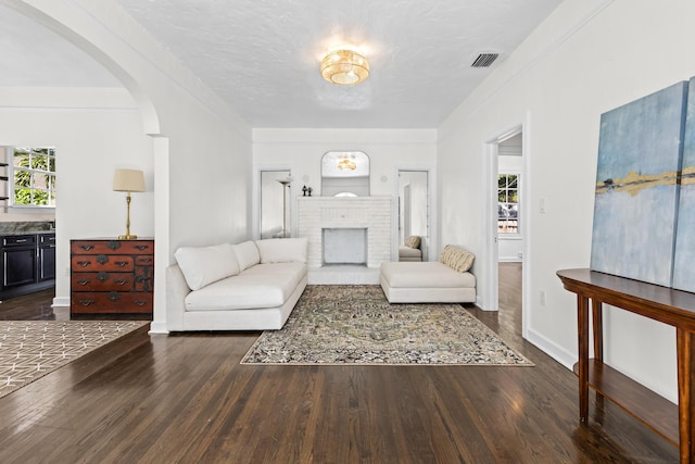 435 35th St, West Palm Beach, FL 33407 - living area with arched walkways, visible vents, a healthy amount of sunlight, and dark wood-type flooring
