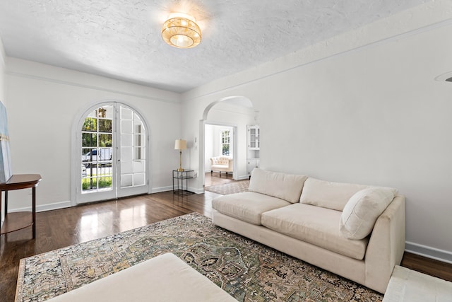 living room featuring dark hardwood / wood-style floors and a textured ceiling