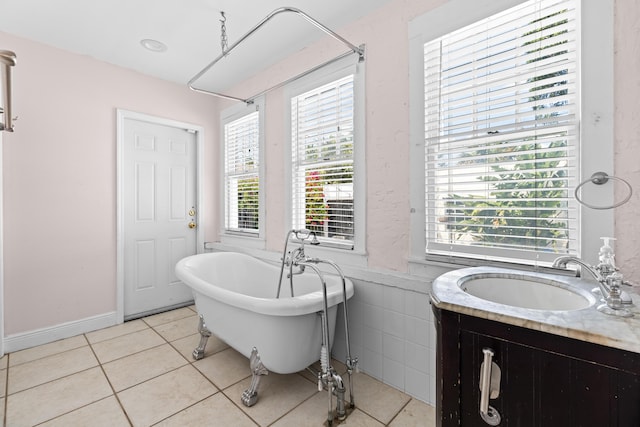 435 35th St, West Palm Beach, FL 33407 - bathroom with a freestanding bath, tile patterned flooring, and vanity