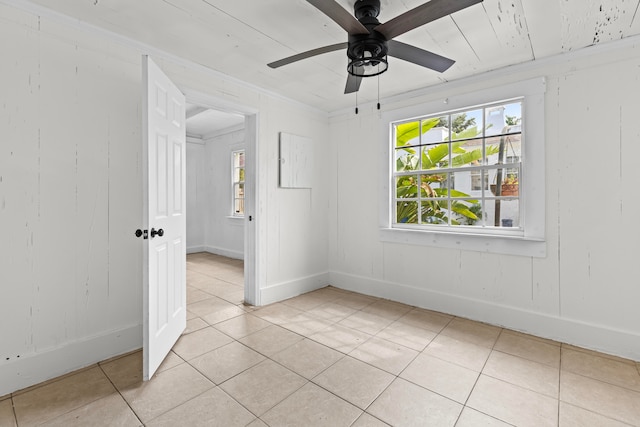 empty room with light tile patterned floors and ceiling fan