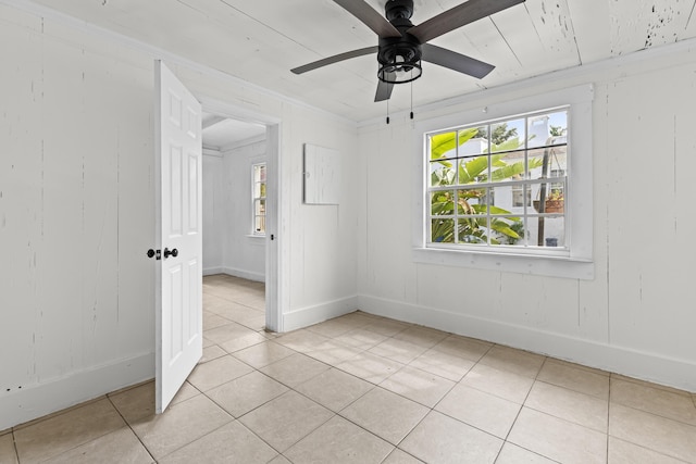 435 35th St, West Palm Beach, FL 33407 - empty room with light tile patterned floors, ceiling fan, and baseboards