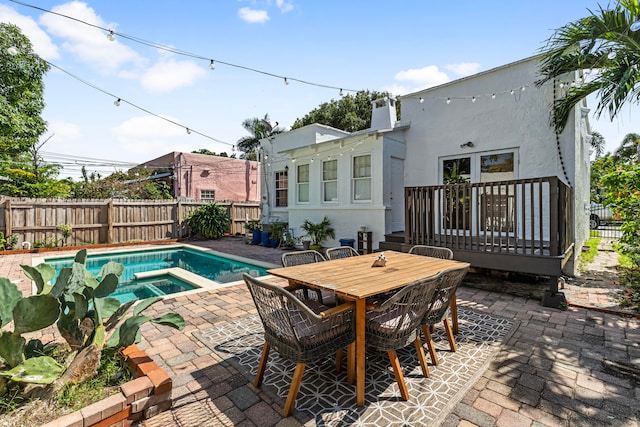 view of swimming pool with an in ground hot tub and a patio area