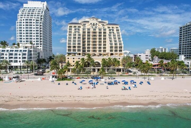 view of property with a beach view and a water view