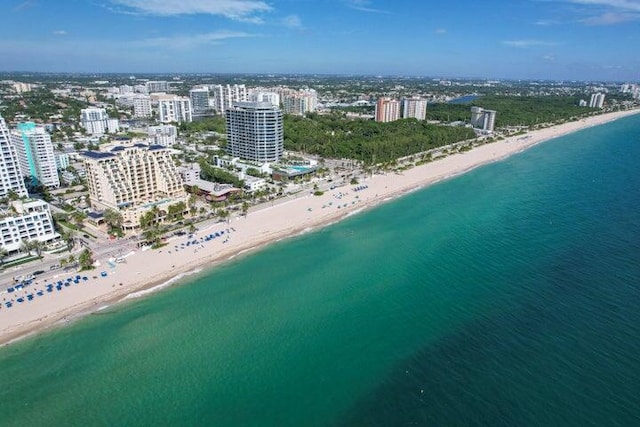 drone / aerial view with a water view and a beach view