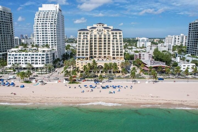 bird's eye view with a water view and a beach view