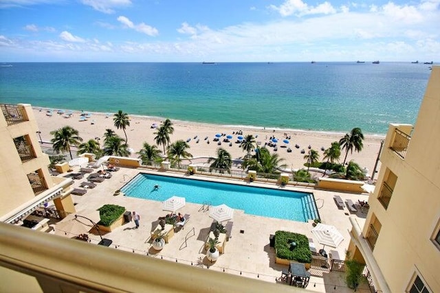 exterior space featuring a water view and a beach view