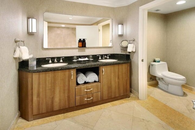 bathroom featuring dual bowl vanity, tile patterned floors, and toilet