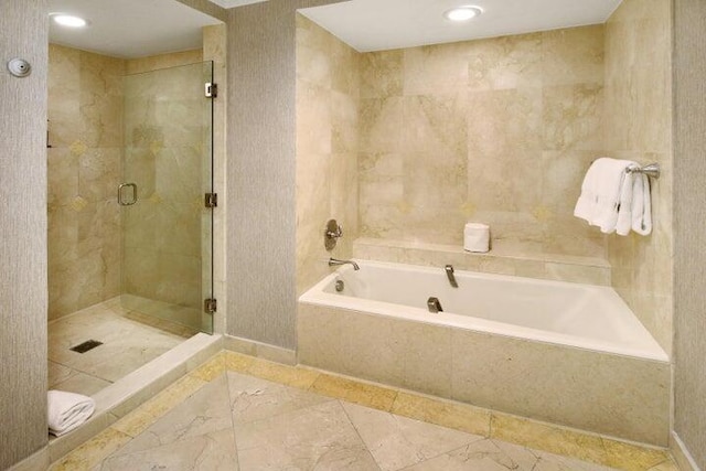 bathroom featuring tile patterned floors and independent shower and bath