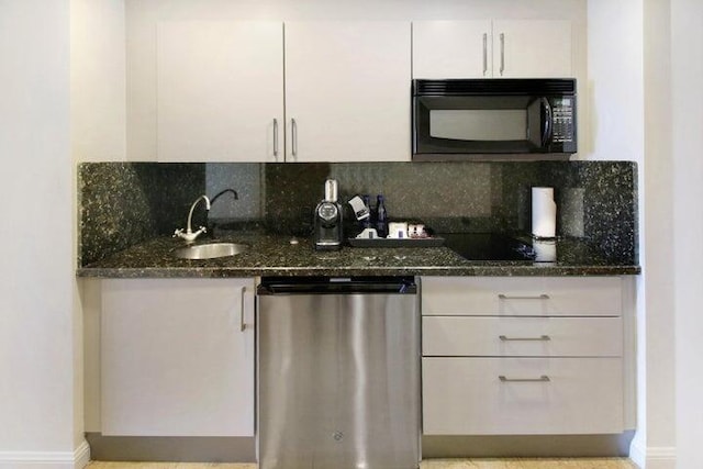 kitchen featuring black appliances, sink, dark stone counters, and backsplash