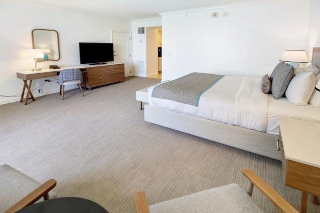 carpeted bedroom featuring crown molding