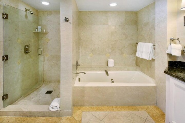 bathroom featuring vanity, tile patterned floors, and shower with separate bathtub