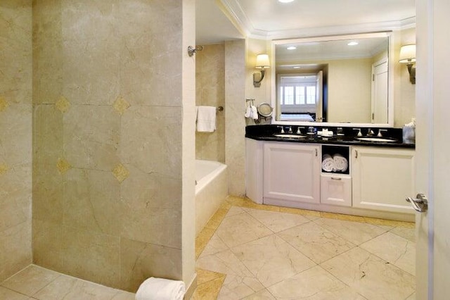 bathroom with ornamental molding, vanity, and shower with separate bathtub