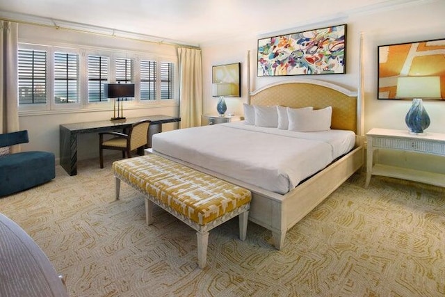 bedroom featuring crown molding and light carpet