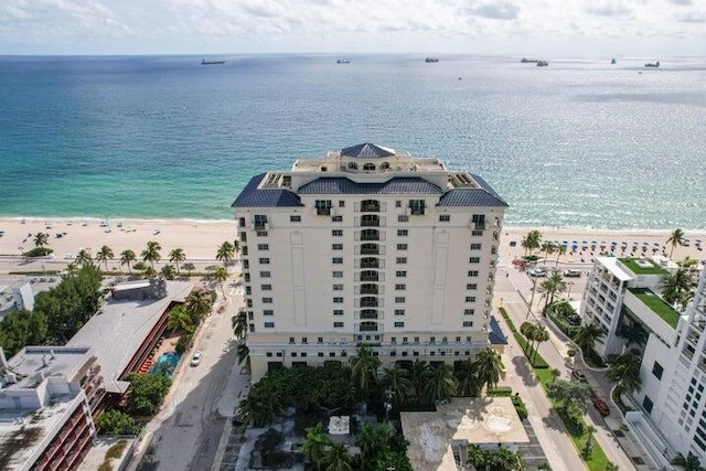 drone / aerial view with a beach view and a water view