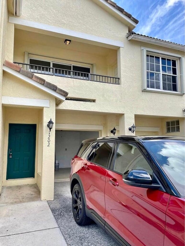 view of front of home featuring a balcony and a garage