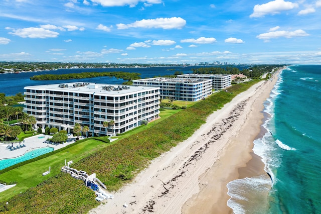 drone / aerial view featuring a water view and a view of the beach