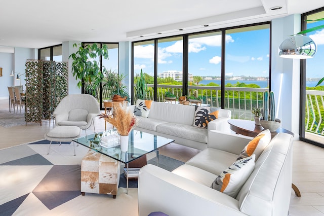 living room with a water view and a wall of windows