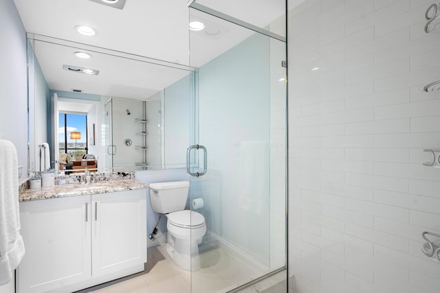 full bath with a shower stall, vanity, and tile patterned floors