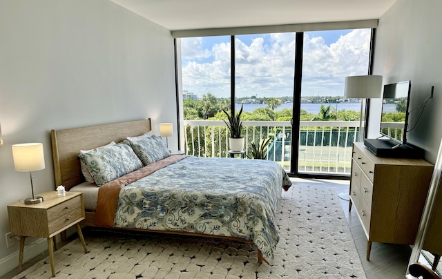 bedroom with expansive windows and light tile patterned floors