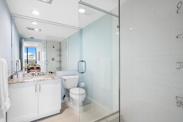 bathroom featuring vanity, toilet, tile patterned floors, and a shower with door